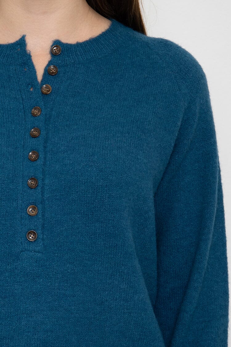 Pull avec bouton pull